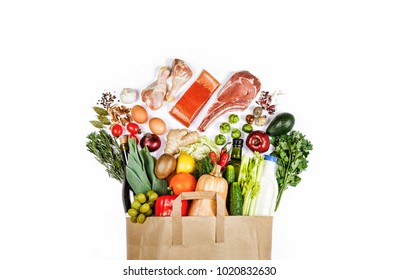 Supermarket. Paper bag full of healthy food on a white background. Top view. Flat lay - Powered by Shutterstock