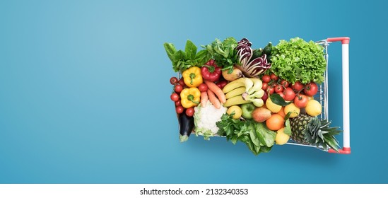 Supermarket shopping cart full of fresh vegetables and fruits, healthy organic food concept - Shutterstock ID 2132340353