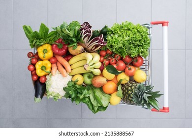 Supermarket shopping cart full of fresh vegetables and fruits, healthy organic food concept - Shutterstock ID 2135888567