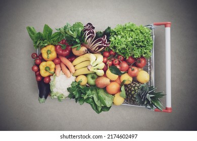 Supermarket shopping cart full of fresh vegetables and fruits, healthy organic food concept - Shutterstock ID 2174602497