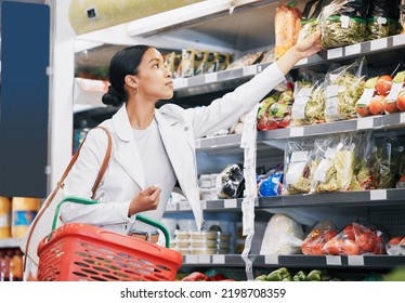 Supermarket, Shopping And Customer In Retail Store For Vegetable Food, Groceries Or Product From Shelf. Young Woman With Basket During Inflation Price Increase, Discount Or Sales Choice On Grocery