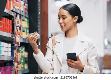 Supermarket, Shopping And Customer With Smartphone Check Price, Label Or Product Information Online. Retail Consumer Woman With Food Or Grocery Checking Discount Code Or Sales Choice On A Digital App