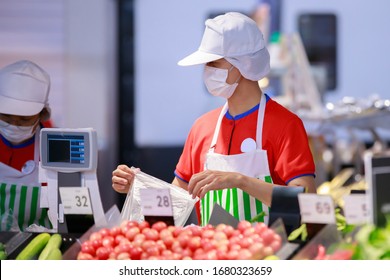 Supermarket Staff In Medical Protective Mask Working At Supermarket.covid-19 Spreading Outbreak  