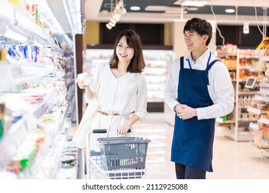 Supermarket staff talking with customers - Powered by Shutterstock