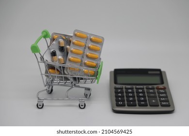 A Supermarket Trolley Full Of Blister Pills, A Lot Of Pills In A Wheelbarrow. Concept: Home Delivery Of Medicines.Empty Space, A Place For Text, Poster, Board. Medical Blue Background