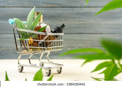 Supermarket Trolley With Marijuana Leafs And Medical Cannabis Oil Cbd