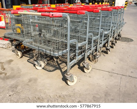 Supermarket trolley, at the outdoor in front of the shopping place in area of car parking, local place 