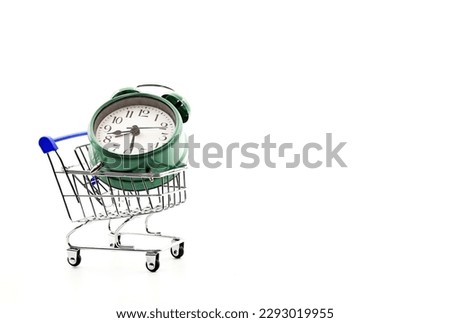 A supermarket trolley or shopping cart with an antique or vintage alarm clock