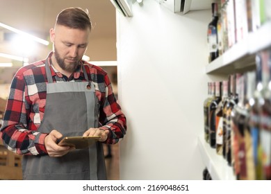 Supermarket Worker Using Digital Tablet, Grocery Store Employee Orders Groceries Online, Innovative Technology And Work Concept