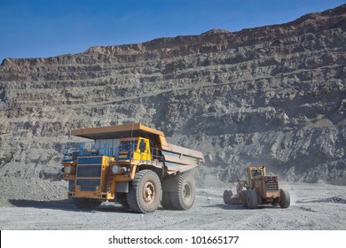 The supersize car and grader in open pit mine