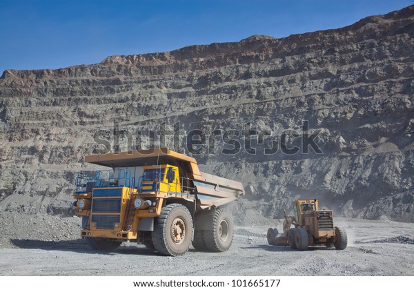 The supersize\
car and grader in open pit\
mine