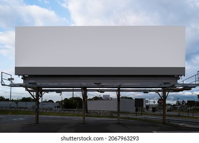 Supersize white rectangular advertising billboard on the street at the highway entrance in Boston, Massachusetts.