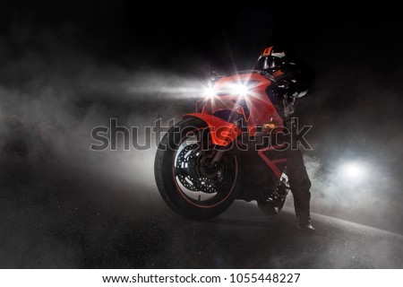 Supersport motorcycle driver at night with smoke around. Dark motorbike wallpaper