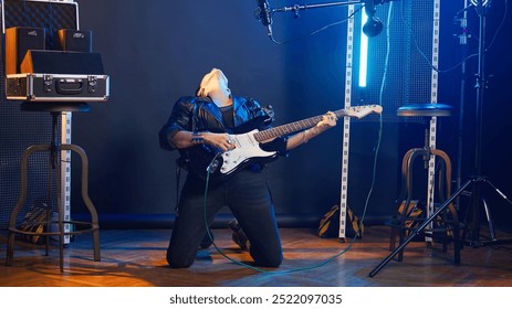 Superstar girl with an electric guitar rocks out in a live show, the crowd enjoying her bold edgy attitude and loud heavy metal alternative music. Female rocker in a leather jacket. Camera A. - Powered by Shutterstock