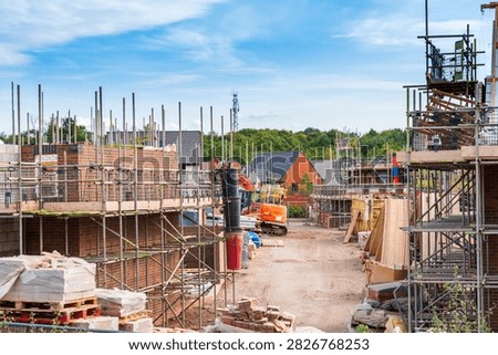Superstructure brickwork and scaffolding on a modern residential housing development site