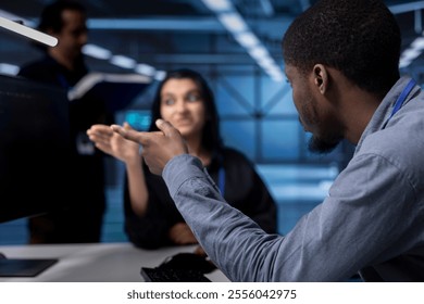 Supervisor arguing with engineer worker after seeing error in server room equipment. Close up shot of annoyed manager berating employee in data center after noticing malfunction - Powered by Shutterstock