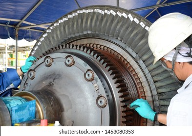 Supervisor conducting gas turbine overhaul and cleaning for inspection of gas turbine blades. - Powered by Shutterstock