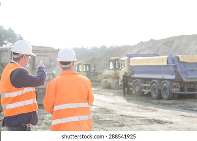 Supervisor Explaining Plan To Colleague At Construction Site