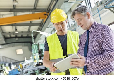Supervisor And Manual Worker Using Digital Tablet In Metal Industry
