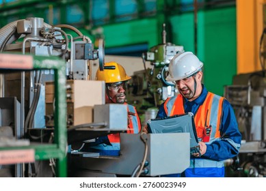 A supervisor mentors a technician using a rugged laptop beside a production machine in a manufacturing facility, showing digital supervision, faster troubleshooting, productivity, and process control.