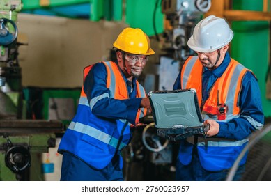 A supervisor mentors a technician using a rugged laptop beside a production machine in a manufacturing facility, showing digital supervision, faster troubleshooting, productivity, and process control.