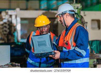 A supervisor mentors a technician using a rugged laptop beside a production machine in a manufacturing facility, showing digital supervision, faster troubleshooting, productivity, and process control.