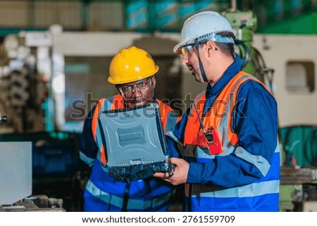 A supervisor mentors a technician using a rugged laptop beside a production machine in a manufacturing facility, showing digital supervision, faster troubleshooting, productivity, and process control.