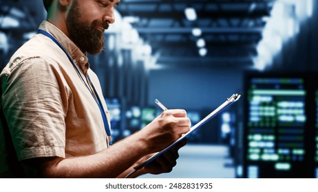 Supervisor monitoring energy efficient servers using renewable sources to minimize consumption and reduce overall facility carbon footprint. Technician working in eco friendly data center