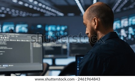 IT supervisor overseeing server room, running code on PC, troubleshooting rigs. Software admin upgrading hardware clusters, networking systems and storage arrays, close up shot