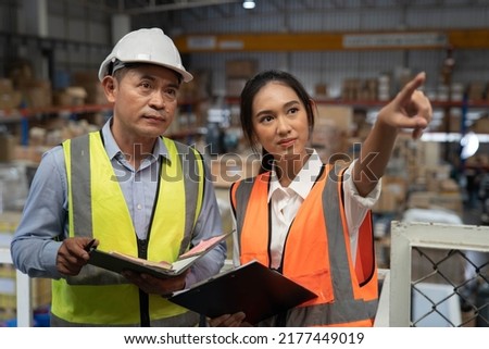 Supervisor and staff working in factory ware house discuss about parts inventory and storage location 
