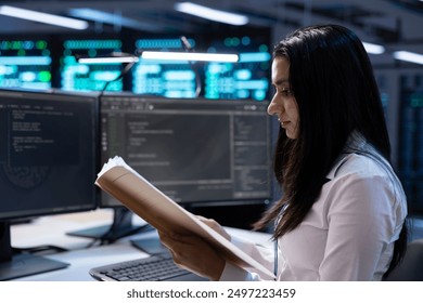 IT supervisor verifying data center infrastructure documentation paperwork, configurations and procedures. Server farm inspector reading performance benchmarks and conducting analysis