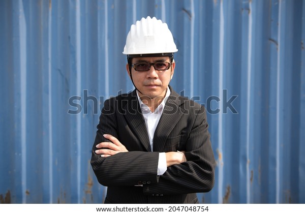 Supervisors of Asian, at the logistic, port,\
Container\
background.
