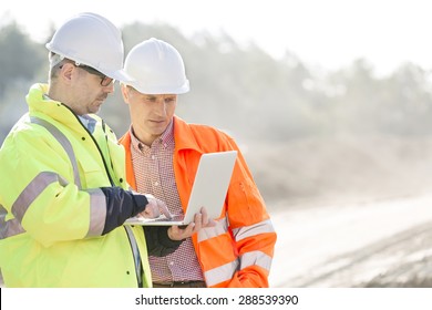 Supervisors Using Laptop At Construction Site