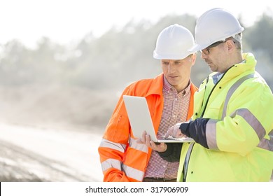 Supervisors Using Laptop At Construction Site