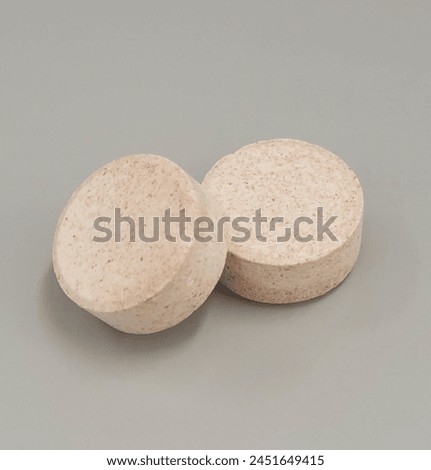 Supplement chewable tablets on white surface