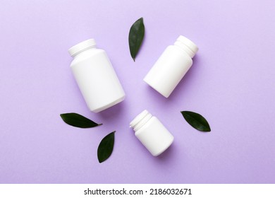 supplement pills with medicine bottle health care and medical top view. Vitamin tablets. Top view mockup bottle for pills and vitamins with green leaves, natural organic bio supplement, copy space. - Shutterstock ID 2186032671