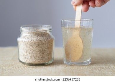 Supplement of psyllium husk and soluble fiber for the intestines. Mixing psyllium with water. Sustainability  - Shutterstock ID 2236957285