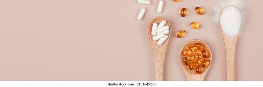 Supplements for health ,vitamin D zinc and vitamin C powder in wooden spoons on beige background.copy space top view.healthy lifestyle concept. banner - Shutterstock ID 2131645273