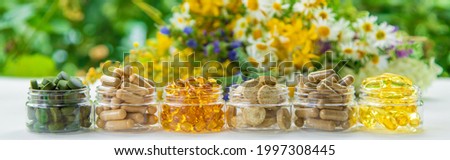 Supplements and vitamins with medicinal herbs. Selective focus. Nature.