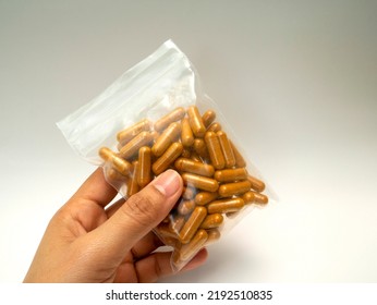Supplements, Vitamins, Or Pills For Health Care And Treatment. Curcuma Capsules. The Hand Is Holding The Curcuma Capsules In The Ziplock Bag.
