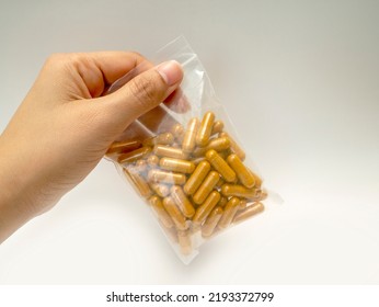 Supplements, Vitamins, Or Pills For Health Care And Treatment. Curcuma Capsules. The Hand Is Holding The Curcuma Capsules In The Ziplock Bag.