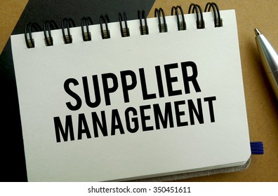 Supplier management memo written on a notebook with pen