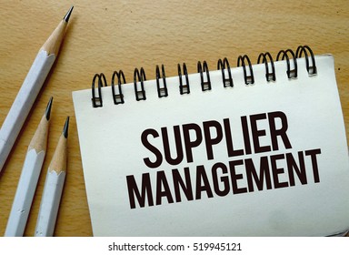 Supplier Management Text Written On A Notebook With Pencils