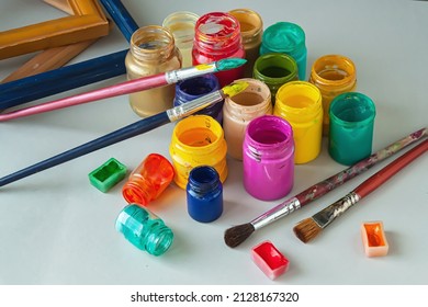 Supplies for painting. Acrylic paints, paintbrush and wooden frames.	 - Powered by Shutterstock