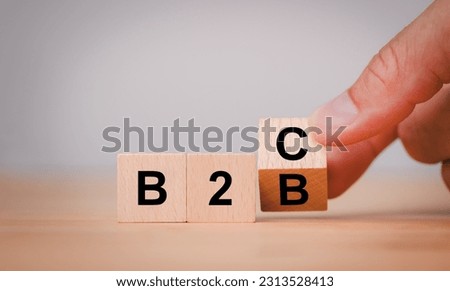 Supply change between Business supplier and customer relations concept with Hand flipping wooden cubes block for change wording B2B to B2C.