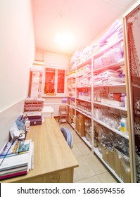 A Supply Clean Hold Closet With Shelves Of Various Medical Equipment And Supplies At A Regional Hospital. Sanitizer. Stocked Shelves Of Medical Scrubs.