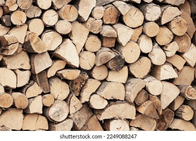 A supply of split and dried hardwood logs stacked up and ready for a cold winter - Shutterstock ID 2249088247