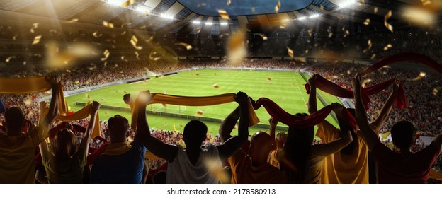 Support. Back view of football, soccer fans cheering their team with colorful scarfs at crowded stadium at evening time. Concept of sport, cup, world, team, event, competition