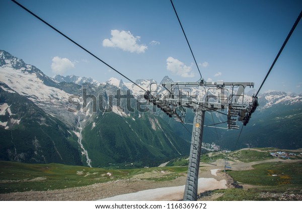 support cable way on the background of the Caucasus\
mountains, summer Sunny\
day