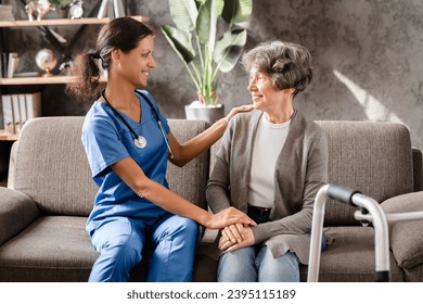 Support and care. Trustful and confident caregiver helping aiding senior patient with movements, treatment. Immobility disease, handicapped old woman - Shutterstock ID 2395115189